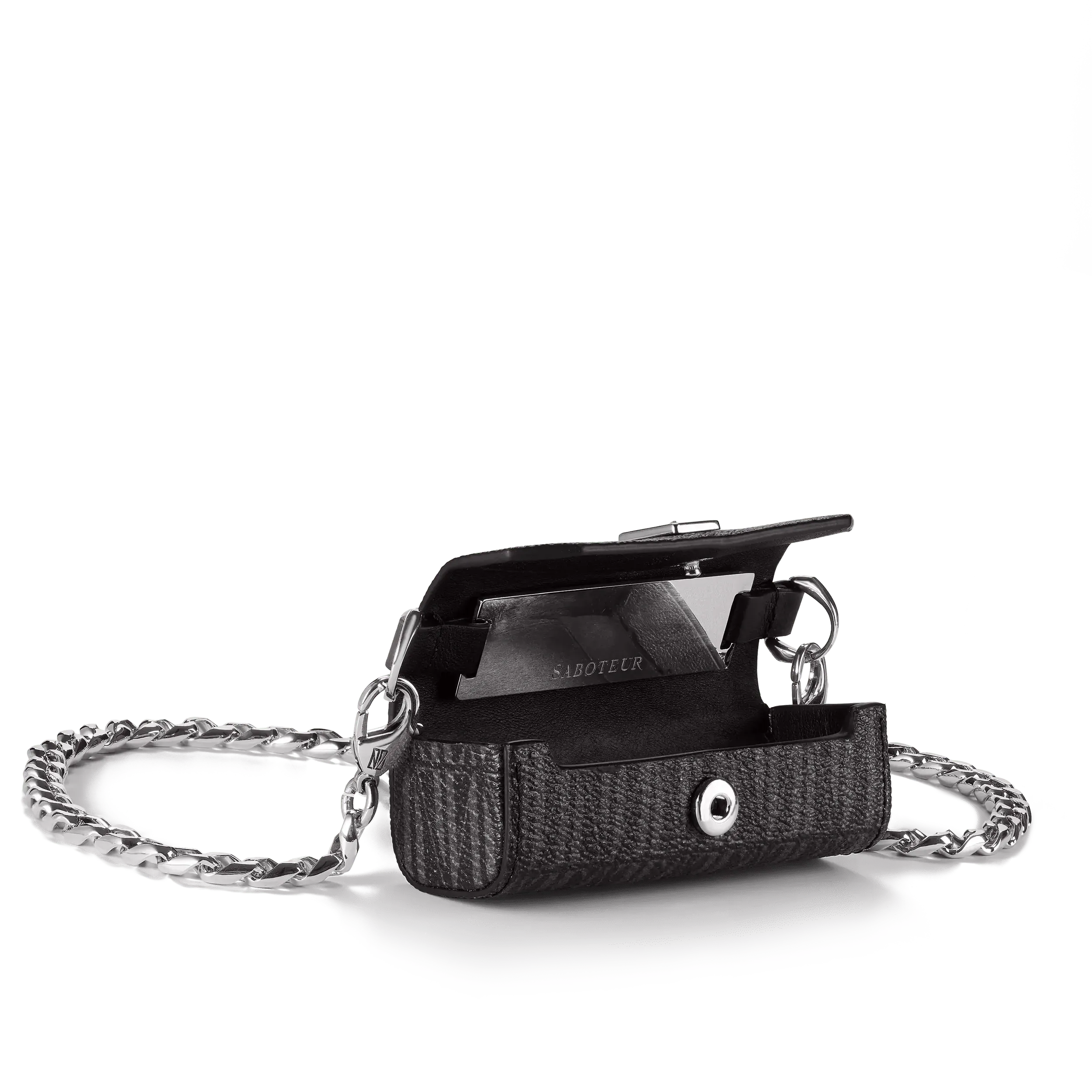 A black leather belt with a silver buckle labeled 'Saboteur' resting on a foam block, surrounded by a coiled silver chain.
