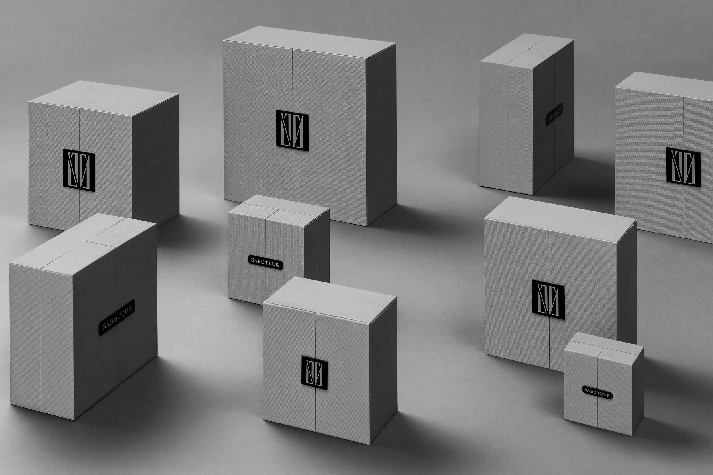 Several white boxes of different sizes with black labels and logos on a light gray surface and background.